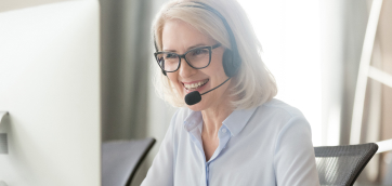 Smiling female with a phone headset on - HealthStream